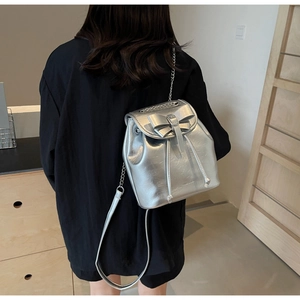 Silver metallic bucket backpack with a bow detail and drawstring closure shown on back