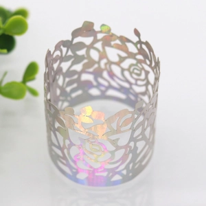 Macro detail of laser-cut paper napkin ring with iridescent silver rose floral patterns