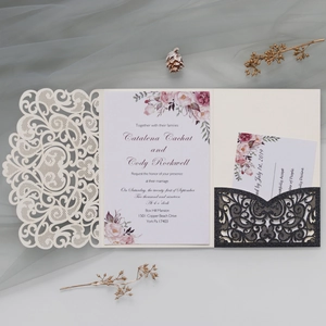 Detail of laser-cut wedding invitation with floral insert and black glitter RSVP pocket