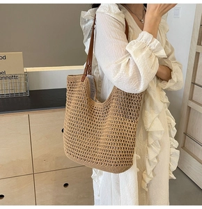 Detail of hand-woven mesh tote with premium brown leather handle and metal rivets