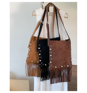 Detail of fringe tassel crossbody bags with vintage rivets in tan, black and coffee