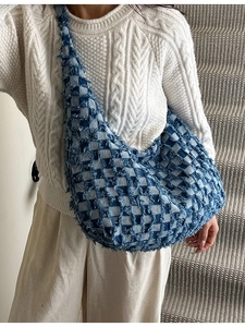 Blue and white checkered denim hobo tote bag with frayed edges and wide shoulder strap