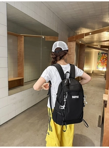 Close-up of black waterproof nylon backpack with white adjustable buckles and DAPING logo
