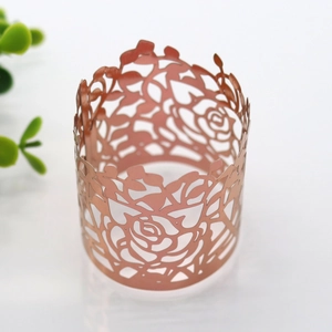 Macro shot of rose gold laser-cut napkin ring featuring intricate floral paper patterns