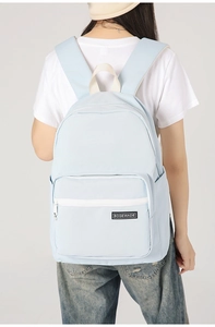 Light blue minimalist laptop backpack featuring front zipper pocket and side pouches