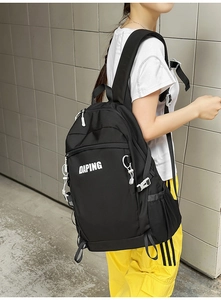 Side view of large black nylon backpack with white DAPING lettering and side buckles
