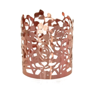 Detail of rose gold laser-cut napkin ring with elegant hollow rose flower pattern