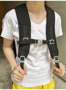 Detail of adjustable black nylon chest strap and gray plastic buckle for backpacks