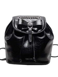 Elegant black glossy leather backpack with silver chain and bow detail on white background