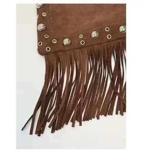 Detailed view of silver rivets and long fringes on a dark brown suede bucket bag