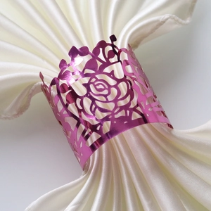 Detail view of pink rose napkin ring with laser-cut hollow design for table decor