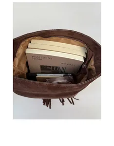 Detail view of the spacious inner compartment of the brown suede fringe bucket bag