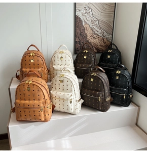 Close-up of patterned backpacks featuring metal studs and rabbit motifs in four colors
