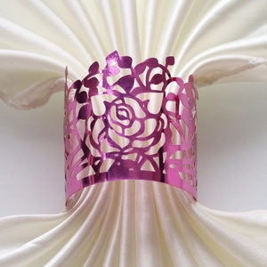 Detail of rose red paper napkin ring with laser-cut hollow rose pattern for table decor