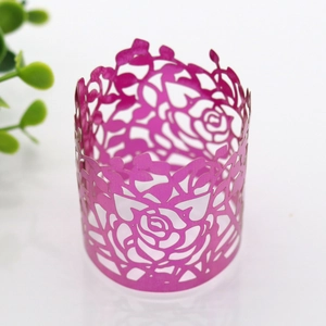 Detailed close-up of rose-pink laser cut paper napkin ring with floral rose patterns
