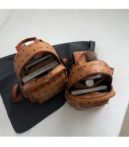 Detail view of large and small brown monogram backpacks showing interior storage capacity
