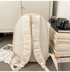 Detail of breathable honeycomb mesh back and ergonomic straps on the canvas backpack