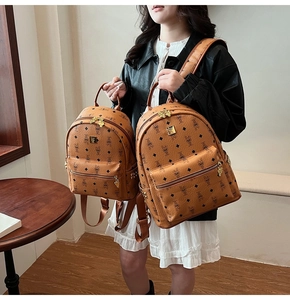 Detailed comparison of large and small brown PU leather backpacks with cartoon rabbit print