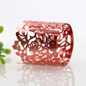 Detailed close-up of rose red hollowed-out rose pattern napkin ring with metallic luster