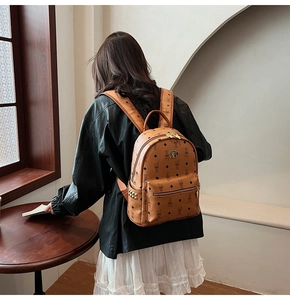 Classic brown monogram backpack with gold-tone hardware and studs shown on model