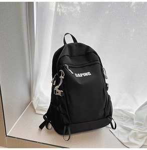 Detail of a large black travel backpack with multiple pockets and white DAPING logo