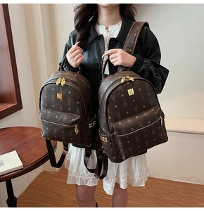 Detail view of deep brown leather backpack with cartoon rabbit print and gold rivets