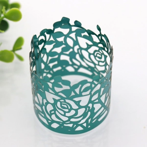 Detail of laser-cut rose floral paper napkin ring in elegant teal for party decor