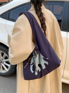 Deep purple canvas tote bag featuring light blue elephant print and knotted shoulder strap