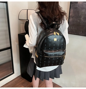 Fashion black backpack with monogram pattern and rabbit design on a model back