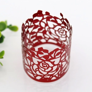 Detailed laser-cut red paper napkin ring featuring intricate rose flower pattern decorations