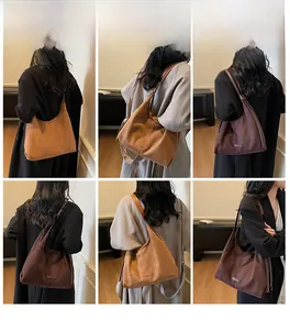 Borsa hobo in pelle scamosciata marrone mostrata da diverse angolazioni su una modella in stanza