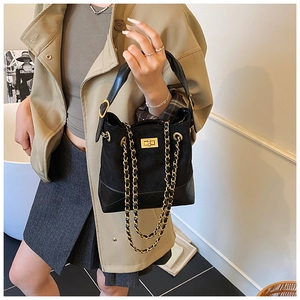 Detail of vintage bucket bag with suede patchwork, quilted base and gold chain strap