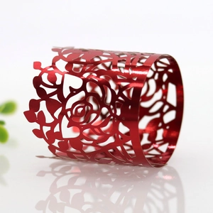 Detailed view of red metallic laser-cut napkin ring with elegant hollow rose patterns