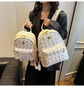 Detail of cream backpack showing large and small sizes with monogram rabbit print