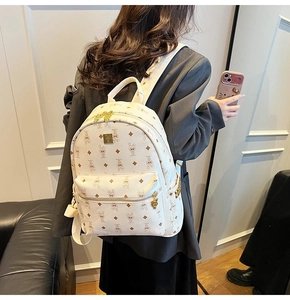 Detail of white fashion backpack with cartoon rabbit print and gold square side studs