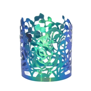 Detailed view of iridescent rose laser-cut napkin ring with blue-green gradient finish