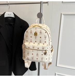 Detail of off-white backpack with cartoon rabbit print and gold metal zipper hardware