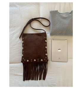 Retro dark brown suede crossbody bag featuring silver rivets and long fringe details