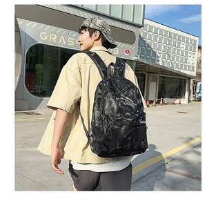 Detailed view of black camo backpack with durable material and street style design