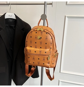 Close-up of brown faux leather backpack featuring bunny prints and golden stud details