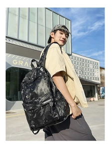 Outdoor close-up of durable camouflage backpack with large capacity and zippered pocket