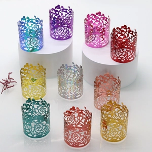 Laser-cut rose napkins rings in ten vibrant metallic colors displayed on pedestals