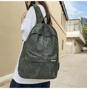 Side view of dark green camouflage backpack with premium texture and logo detail