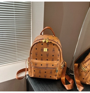Detail view of cognac backpack with rabbit monogram print and golden metal hardware