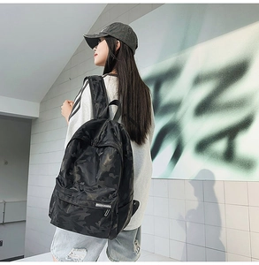 Detail of black camouflage backpack with side pocket and durable street style design