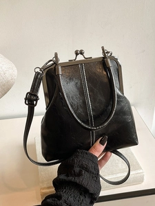 Vintage black oil wax leather shell bag with metal frame clasp and long crossbody strap