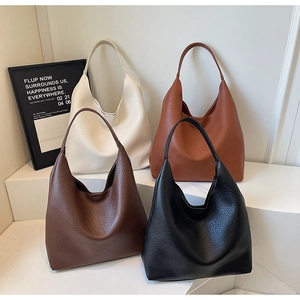 Hobo shoulder bags in white, brown, coffee and black on a white tiered display stand