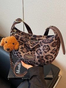 Leopard print hobo shoulder bag with plush pendant for autumn winter fashion styles