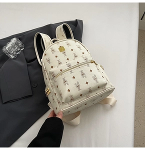 Detail of cream backpack featuring rabbit prints, gold hardware, and premium leather texture