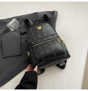 Detail of black faux leather backpack with rabbit monogram print and gold hardware